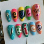 Colorful pastel press-on nails with playful protest lettering spelling ‘Eat the Rich’ – vibrant handmade art nails by Get Nailed by Rach pastel protest nails candy colored press on nails eat the rich aesthetic nails hand painted nail art bold feminist nail set art nails with a message custom colorful nail design cute but angry nails deluxe press on protest nails political statement nail art