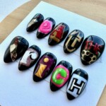 black protest nails eat the rich press on nails luxury anti-capitalist nail art edgy political nail design blackout nail set handmade activist nails deluxe custom press on nails statement nails for revolutionaries punk rock nail art feminist protest nails Black hand-painted press-on nail set with ransom-style ‘Eat the Rich’ lettering and high-gloss finish – deluxe protest art nails by Get Nailed by Rach.