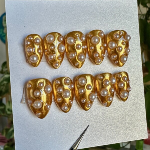 edgy pearl press on nails gothic pearl nail art black and white nail design luxe grunge nails hand painted pearl nails custom deluxe press on nails statement nails with pearls pearl embellished nail set alt glam press on nails pearlcore nail aesthetic Gold chrome deluxe press-on nail set with 3D pearl accents and moody, glam design – handmade by Get Nailed by Rach.