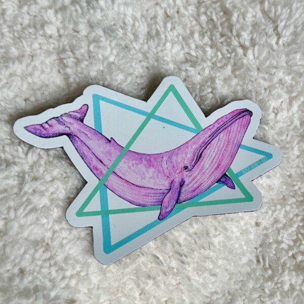 Magnet featuring a pink watercolor blue whale framed by blue and teal geometric triangles in a retro 80s design style.